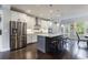 Modern kitchen featuring stainless steel appliances, an island with seating, and pendant lighting at 4104 Townsend Ln, Dunwoody, GA 30346