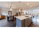 Open kitchen with a large island, pendant lighting, and seamless flow into the dining and living areas at 4104 Townsend Ln, Dunwoody, GA 30346