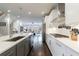 Open kitchen features white cabinets, quartz countertops, and stainless steel appliances, connecting seamlessly to the living room at 4104 Townsend Ln, Dunwoody, GA 30346