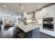 Open concept kitchen with stainless appliances, white cabinets, island, and view to living area at 4104 Townsend Ln, Dunwoody, GA 30346