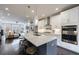 Modern kitchen showcasing an island with barstool seating, stainless steel appliances, and open layout to living room at 4104 Townsend Ln, Dunwoody, GA 30346
