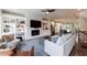 Open-concept living room with a stacked stone fireplace, built-in shelving, and hardwood floors at 4104 Townsend Ln, Dunwoody, GA 30346