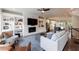 Inviting living room with fireplace, built-in shelving, and open floor plan connected to the modern kitchen at 4104 Townsend Ln, Dunwoody, GA 30346