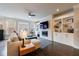 Bright living room featuring a fireplace, built-in shelving, hardwood floors, and large windows at 4104 Townsend Ln, Dunwoody, GA 30346