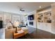 Bright living room featuring a modern fireplace, custom built-ins, and hardwood floors at 4104 Townsend Ln, Dunwoody, GA 30346