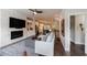 Inviting living room with fireplace, built-in shelving, and open floor plan connected to the modern kitchen at 4104 Townsend Ln, Dunwoody, GA 30346