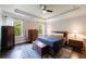 Comfortable bedroom with tray ceilings, hardwood floors, and natural light streaming through the windows at 4104 Townsend Ln, Dunwoody, GA 30346