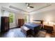 Relaxing bedroom with natural light, ceiling fan, tray ceiling, and hardwood floors at 4104 Townsend Ln, Dunwoody, GA 30346