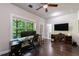 Office space with a large desk, ceiling fan, and exterior door to balcony at 4104 Townsend Ln, Dunwoody, GA 30346