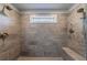This modern shower features dual showerheads, a built in bench and a window for natural light at 4104 Townsend Ln, Dunwoody, GA 30346