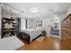 Comfortable bedroom with hardwood floors, a full bed, dresser, and bathroom access at 5839 Darry Cir, Norcross, GA 30093