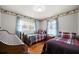 Inviting bedroom featuring two twin beds with matching plaid bedding, and natural hardwood floors at 5839 Darry Cir, Norcross, GA 30093