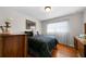 Comfortable bedroom with a cozy bed, a dresser, hardwood floors and large window for natural light at 5839 Darry Cir, Norcross, GA 30093