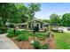 A lush front yard with native plants gives an inviting view of this home's exterior and its green color scheme at 5839 Darry Cir, Norcross, GA 30093