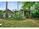 Exterior view of a charming home with green siding surrounded by mature trees and natural landscaping at 5839 Darry Cir, Norcross, GA 30093