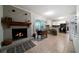 Open-concept kitchen with a brick fireplace, white cabinets, and tile floors at 5839 Darry Cir, Norcross, GA 30093