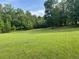 Large, well-maintained grassy backyard surrounded by mature trees offers plenty of space at 1695 Whitley Rd, Dacula, GA 30019