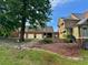 Rear exterior view of the home and garage showing terraced stone and brick landscaping at 1695 Whitley Rd, Dacula, GA 30019