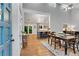 Inviting dining area with wood floors, seamlessly connected to an open-concept kitchen with a breakfast bar at 3726 Scotts Mill Run, Peachtree Corners, GA 30096