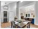 Dining area with hardwood floors, seamlessly connected to an open-concept kitchen and stairway at 3726 Scotts Mill Run, Peachtree Corners, GA 30096