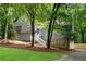 Charming home with stone accents and lush greenery, featuring a stairway leading to the front door at 3726 Scotts Mill Run, Peachtree Corners, GA 30096