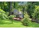 Charming home with a well-maintained front yard and mature trees, creating a serene setting at 3726 Scotts Mill Run, Peachtree Corners, GA 30096