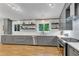 Contemporary kitchen with white countertops, gray cabinets, and stainless steel appliances at 3726 Scotts Mill Run, Peachtree Corners, GA 30096