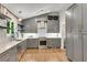Well-designed kitchen features open shelving, gray cabinets and stainless steel appliances at 3726 Scotts Mill Run, Peachtree Corners, GA 30096