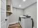 Laundry room with modern washer and dryer and built in storage at 3726 Scotts Mill Run, Peachtree Corners, GA 30096
