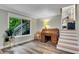 Bright living room featuring hardwood floors, an antique desk, and an inviting view of the outdoors at 3726 Scotts Mill Run, Peachtree Corners, GA 30096
