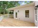 Back porch with wood floor and white railings provides access to a well-maintained, fenced yard at 1036 Dell Se Ave, Smyrna, GA 30080