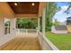 Charming back porch has wood flooring, white railing, and a view of a shed in the green backyard at 1036 Dell Se Ave, Smyrna, GA 30080