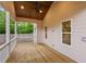Back porch showcases a stained wood ceiling with fan, wood floors, and white railing overlooking backyard at 1036 Dell Se Ave, Smyrna, GA 30080