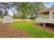 Well-kept backyard featuring a storage shed, a white fence, and access to the porch of the home at 1036 Dell Se Ave, Smyrna, GA 30080