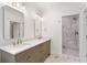 Bathroom featuring double sinks with a marble countertop and walk-in shower at 1036 Dell Se Ave, Smyrna, GA 30080