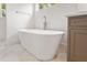 Close-up of bathtub in bathroom with marble floors at 1036 Dell Se Ave, Smyrna, GA 30080