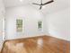 Bright bedroom featuring hardwood floors, a ceiling fan, and two windows at 1036 Dell Se Ave, Smyrna, GA 30080