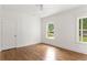 Bedroom features hardwood floors, white trim, ceiling fan and large windows at 1036 Dell Se Ave, Smyrna, GA 30080