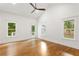 Spacious bedroom with hardwood floors, two windows, and access to outdoor patio at 1036 Dell Se Ave, Smyrna, GA 30080