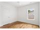 Bedroom features hardwood floors, white trim, ceiling fan and a large window at 1036 Dell Se Ave, Smyrna, GA 30080