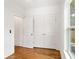 Bedroom featuring double doors, hardwood flooring, and a large window at 1036 Dell Se Ave, Smyrna, GA 30080