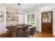 Dining room boasts a stone accent wall, hardwood floors and a modern chandelier at 1036 Dell Se Ave, Smyrna, GA 30080