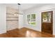 Dining room boasts a stone accent wall, hardwood floors and a modern chandelier at 1036 Dell Se Ave, Smyrna, GA 30080