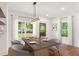 Bright dining room features hardwood floors, modern chandelier and a large window overlooking the front yard at 1036 Dell Se Ave, Smyrna, GA 30080