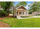 Quaint home featuring a lovely front lawn, welcoming porch, and private driveway at 1036 Dell Se Ave, Smyrna, GA 30080