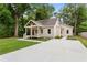 Attractive home with a well-maintained lawn and a long, modern concrete driveway at 1036 Dell Se Ave, Smyrna, GA 30080