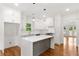 Bright kitchen features a large island, white cabinets, modern lighting and stainless steel appliances at 1036 Dell Se Ave, Smyrna, GA 30080