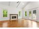 An empty living room featuring a brick fireplace, hardwood floors, and double doors at 1036 Dell Se Ave, Smyrna, GA 30080