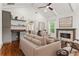 Cozy living room with vaulted ceiling, fireplace, built-in shelving, and large windows at 1036 Dell Se Ave, Smyrna, GA 30080