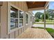 View of the covered porch with natural wood flooring and bright, modern windows at 1036 Dell Se Ave, Smyrna, GA 30080